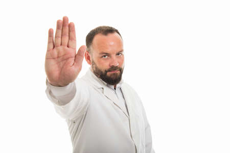 Portrait of male doctor showing stop gesture isolated on white background with copyspace advertising areaの写真素材