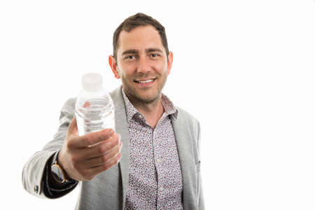 Portrait of business man handing a bottle of water isolated on white background with copyspace...