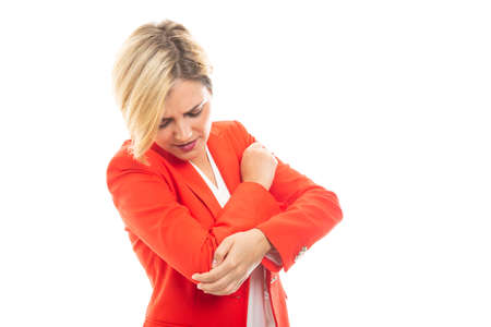 Young pretty business woman showing elbow pain gesture isolated on white background with copyspace...