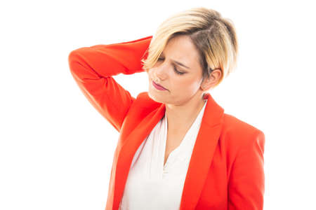 Young pretty business woman showing back headache gesture isolated on white backgroundの写真素材