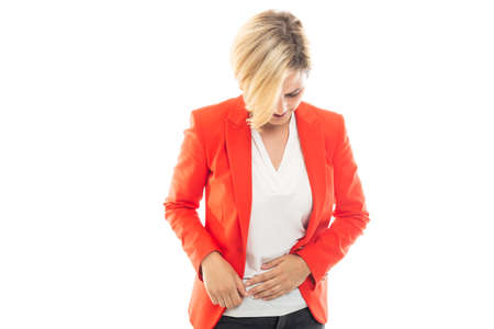 Young pretty business woman showing stomachache gesture isolated on white background with copyspace advertising areaの写真素材