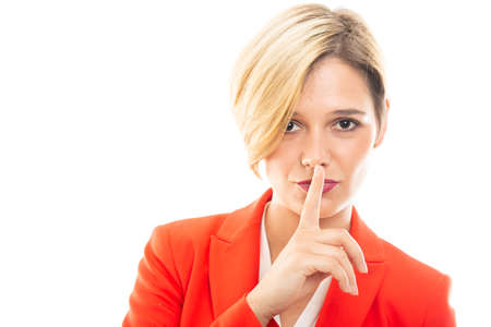 Young pretty business woman showing silent gesture on white background with copyspace advertising areaの写真素材