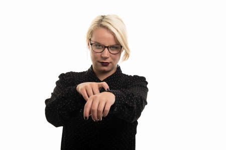 Portrait of young blonde female teacher wearing glasses showing late gesture isolated on white...