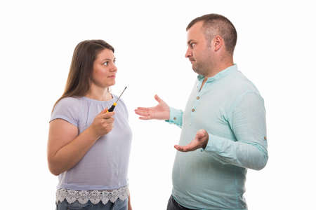 Portrait of young happy couple holding screwdriver isolated on white background with copyspace...
