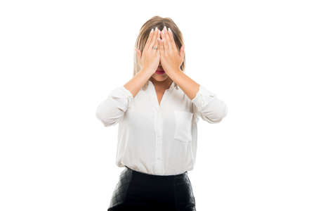 Beautiful business woman covering eyes like not seeing isolated on white background