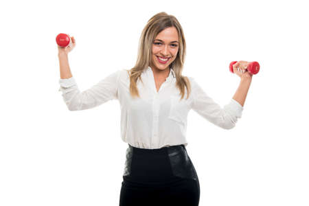 Portrait of beautiful business woman holding two dumbbells like training and smiling isolated on white backgroundの写真素材