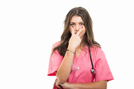 Portrait of beautiful young doctor making look into my eyes gesture isolated on white background with copy space advertising areaの写真素材