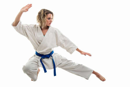 Full body of woman making martial arts pose wearing white outfit isolated on white background