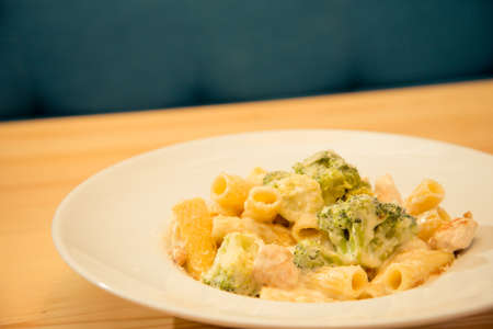 Tasty plate of broccoli and chicken pasta on bistro or restaurant plateの写真素材