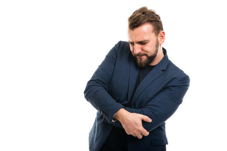 Business man wearing smart casual clothes gesturing elbow ache isolated on white background with copy space advertising areaの写真素材