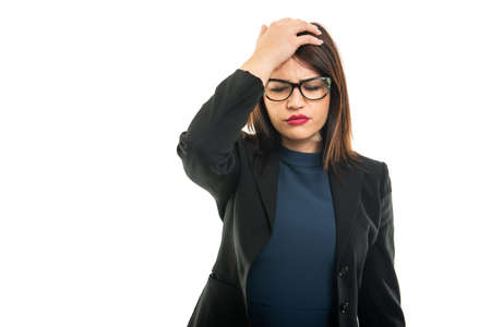 Portrait of young business girl wearing making head ache gesture isolated on white background with copy space advertising areaの写真素材