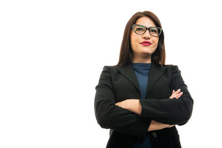 Low angle of business girl wearing glasses standing with arms crossed gesture isolated on white background with copy space advertising areaの写真素材