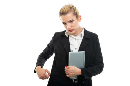 Young female assistant manager holding agenda making confused gesture isolated on white background...