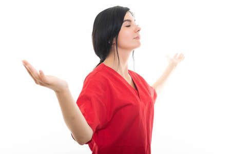 Portrait of young attractive female nurse making winner gesture isolated on white background with...