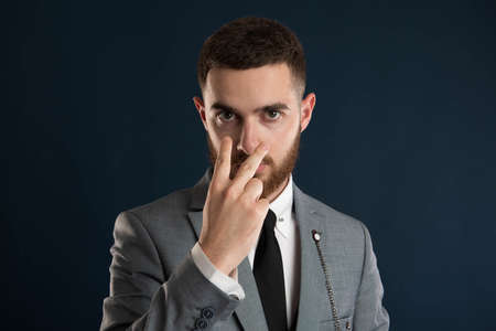 Young entrepreneur saying look intro my eyes wearing a grey suitの写真素材