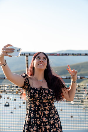 Tourist taking selfie at scenic viewpoint with love locks