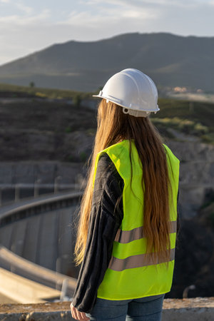 Female engineer inspecting a dams spillway for safety and risk preventionの写真素材