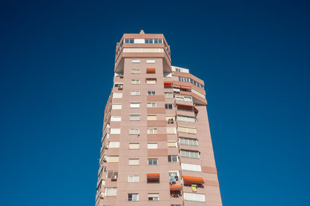 Modern residential building standing tall against clear blue sky