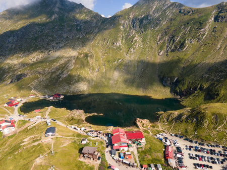 Balea lake reflecting dramatic mountain scenery in the transfagarasan pass