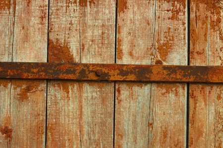 Old wooden door with rusted metal barの写真素材