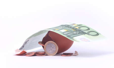 1 Euro coin getting out of cracked hatched egg under 100 euro banknote. Symbol for investment,...