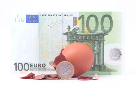 1 Euro coin getting out of cracked hatched egg near 100 euro banknote. Symbol for investment, economy, business, income, banking, financeの写真素材