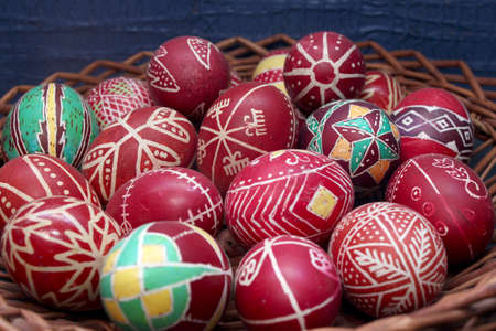 Vintage collection of decorated red easter eggs in basketの写真素材