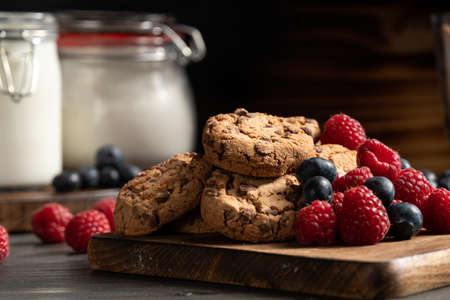 Homemade chocolate cookies with raspberries and blueberiesの写真素材