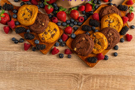 Close up of chocolate cookies with forest fruits with copyspace belowの写真素材