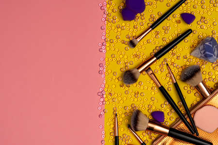 Foundation and eye shadow brushes with golden bagの写真素材