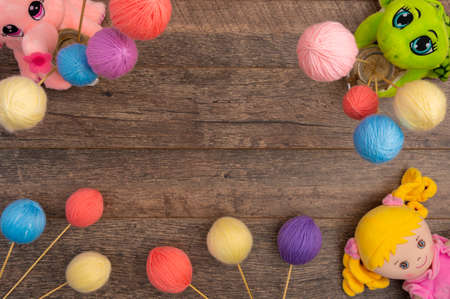 Plush baby toys and yarn balls, with copy spaceの写真素材