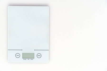 Digital weighing machine on a white backgroundの写真素材