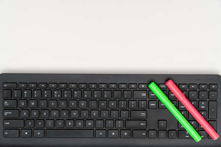 Top view of green and pink markers on keyboardの写真素材