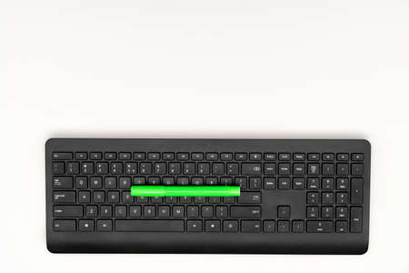 Green marker and black keyboard on white backgroundの写真素材
