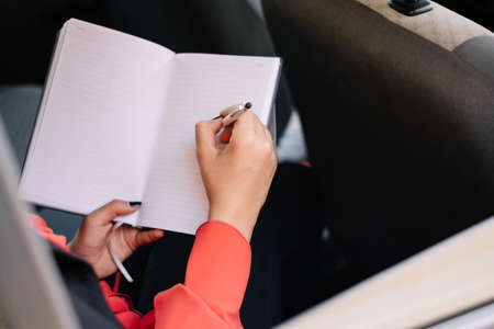 Woman handwriting on backseat of a carの写真素材