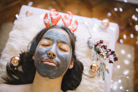 Young girl with face mask and Christmas headband