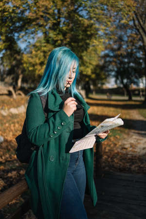 Tourist woman holding a map and sunglassesの写真素材