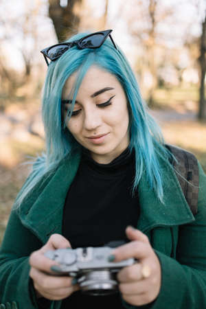 Beautiful girl with blue hair looking into photo cameraの写真素材