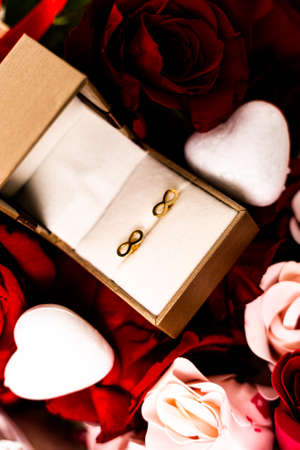 Romantic present for woman for Valentines day. Cropped gift box with golden eternity sign earrings...