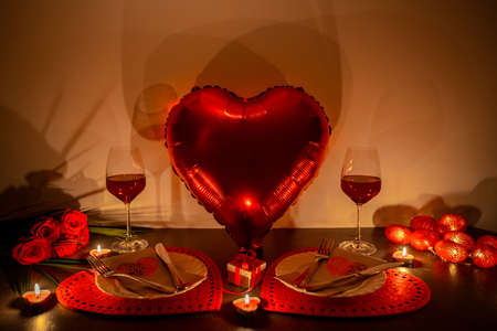 Valentines day dinner with burning candles and balloonの写真素材