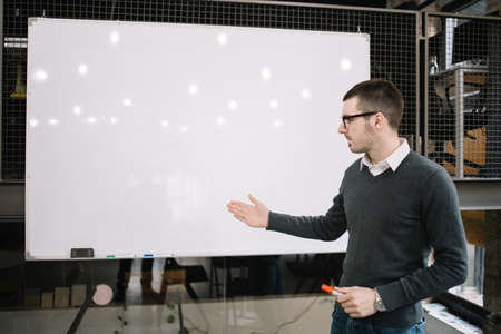Teacher standing at whiteboard in lecture hallの写真素材