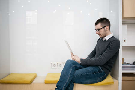 Male employee working on tablet in working space