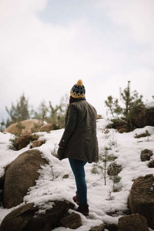 Girl standing on a mount with snow
