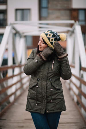 Brunette woman touching her hat with glovesの写真素材