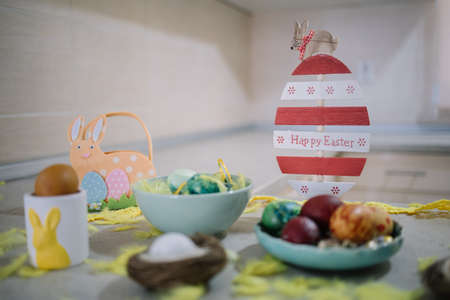 Easter decoration with painted eggs on kitchen countertop