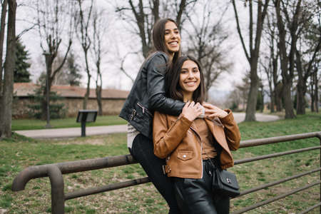 Portrait of sisters hugging and looking at cameraの写真素材