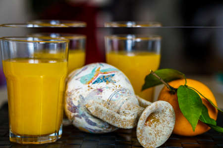 Amphora on a tray with fresh juice in cups
