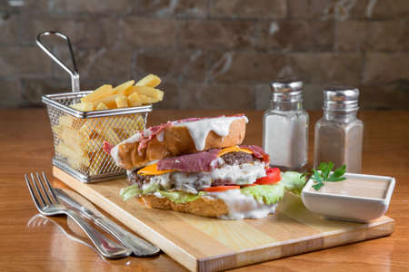 Sandwich with cedar and meat on wooden boardの写真素材