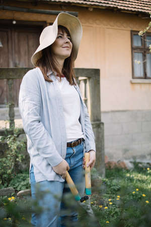 Dreamy woman looking at sky while standing in the garden