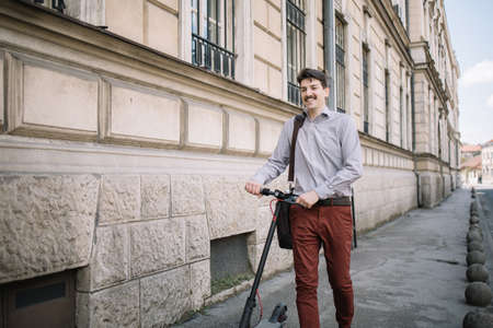 Happy man in elegant outfit walking on sidewalk